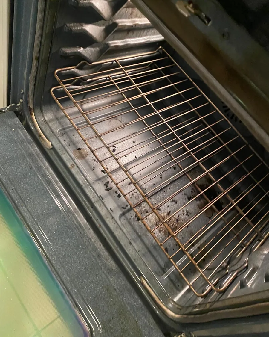 Oven interior with burnt-on grease before deep cleaning