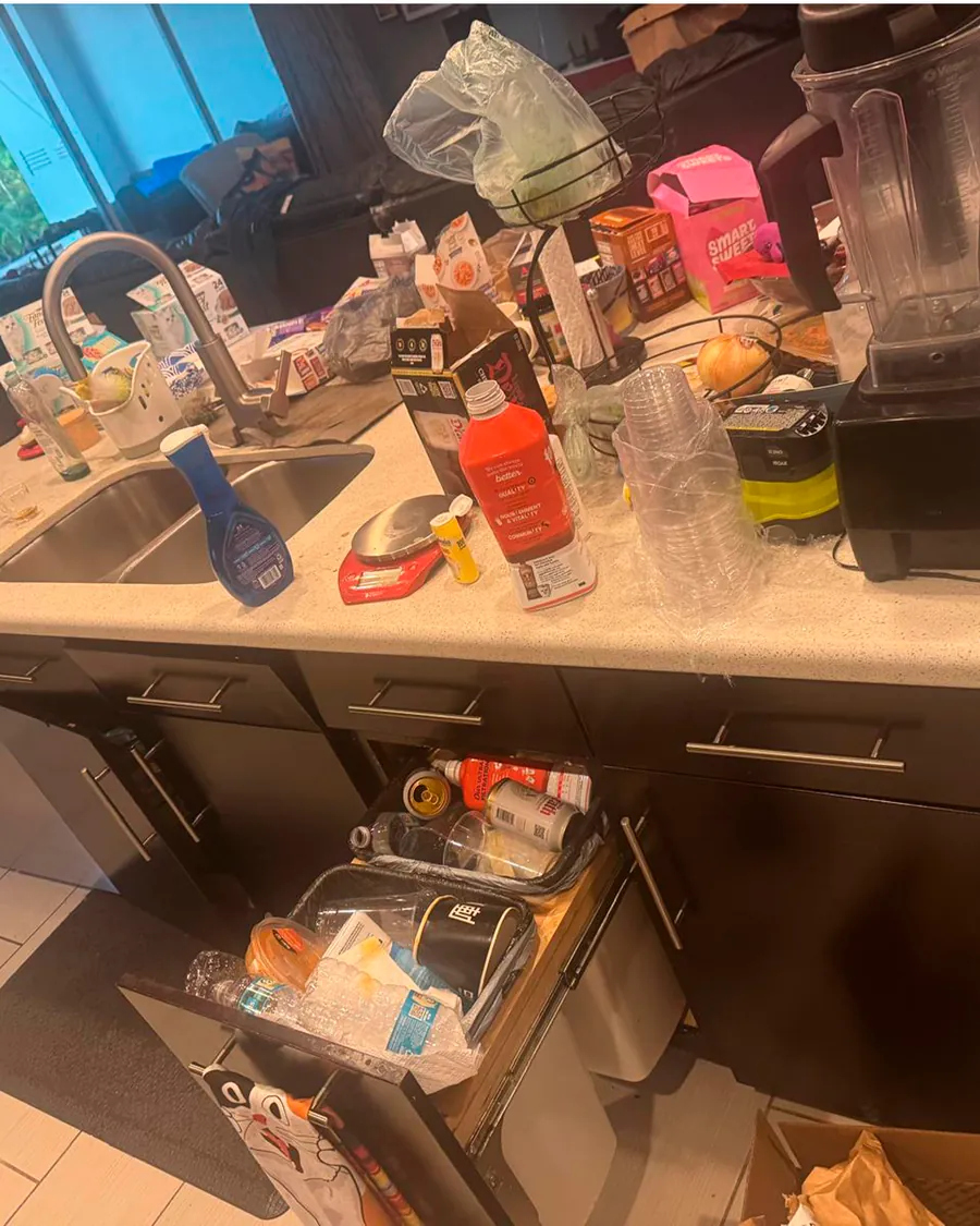 Cluttered kitchen counter before cleaning