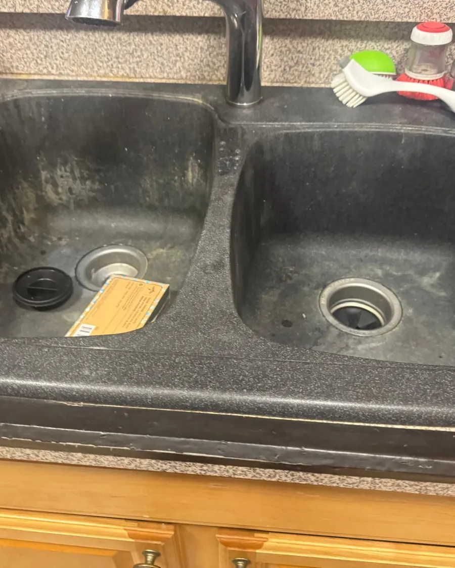 Kitchen sink with built-up grime before cleaning